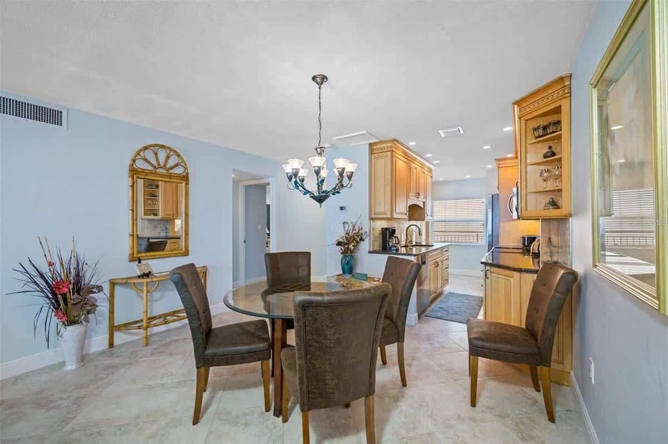 Living room and kitchen area in our vacation rental with oceanfront view of Madeira Beach.