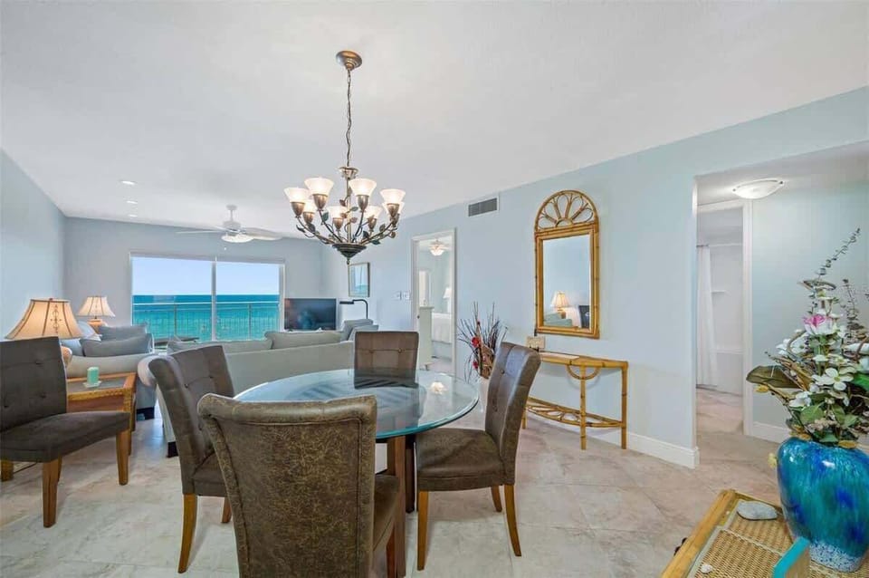 Comfortable dining room table with seat for four in our vacation rental with oceanfront view of Madeira Beach.