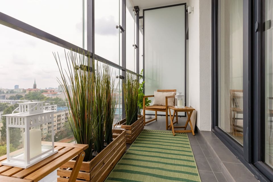 The balcony's stylish design complements the apartment's decor. 