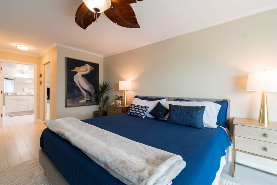 Spacious bedroom with a king-size bed and calming coastal artwork.