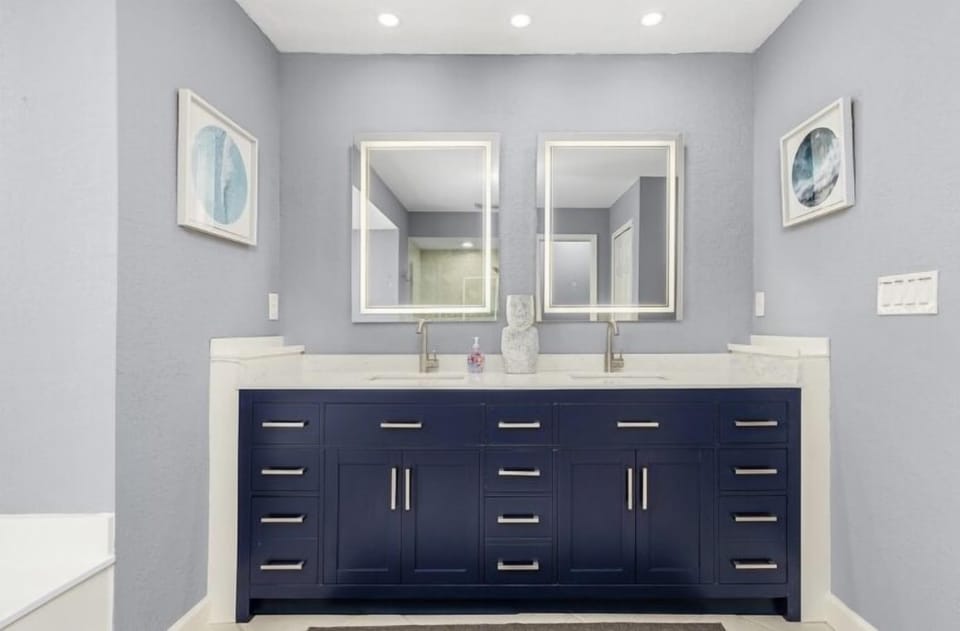 MASTER BATHROOM HAS NEW DOUBLE VANITY AND MODERN LIGHTED MIRRORS