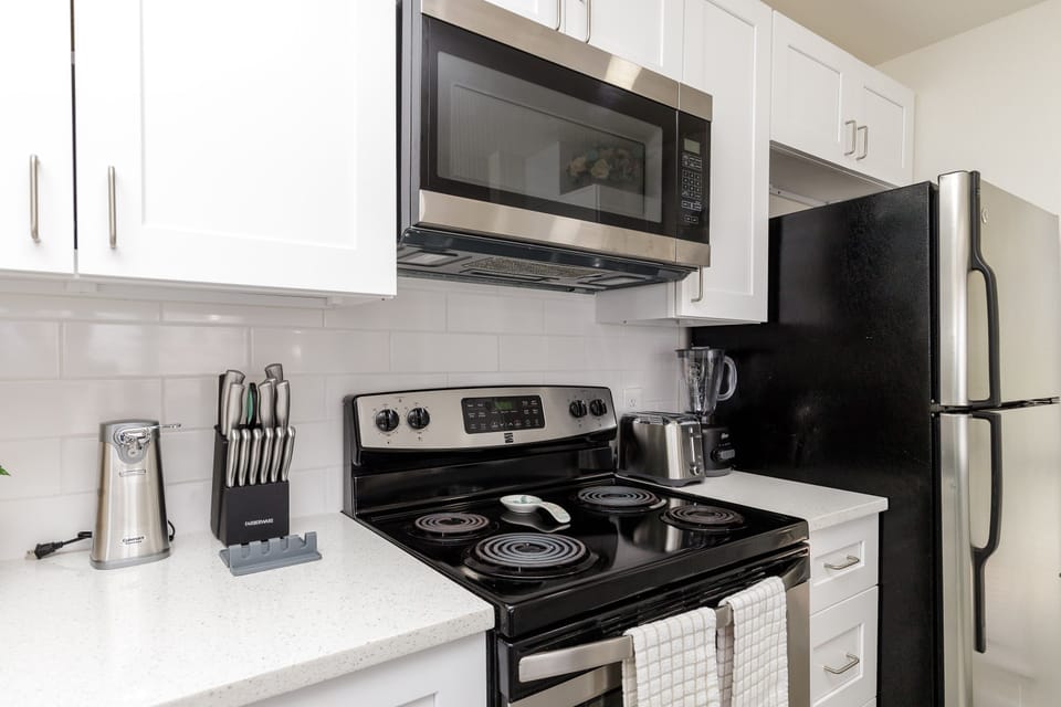 Prepare your favorite meals in this fully-equipped kitchen featuring modern appliances and ample counter space for all your culinary adventures.