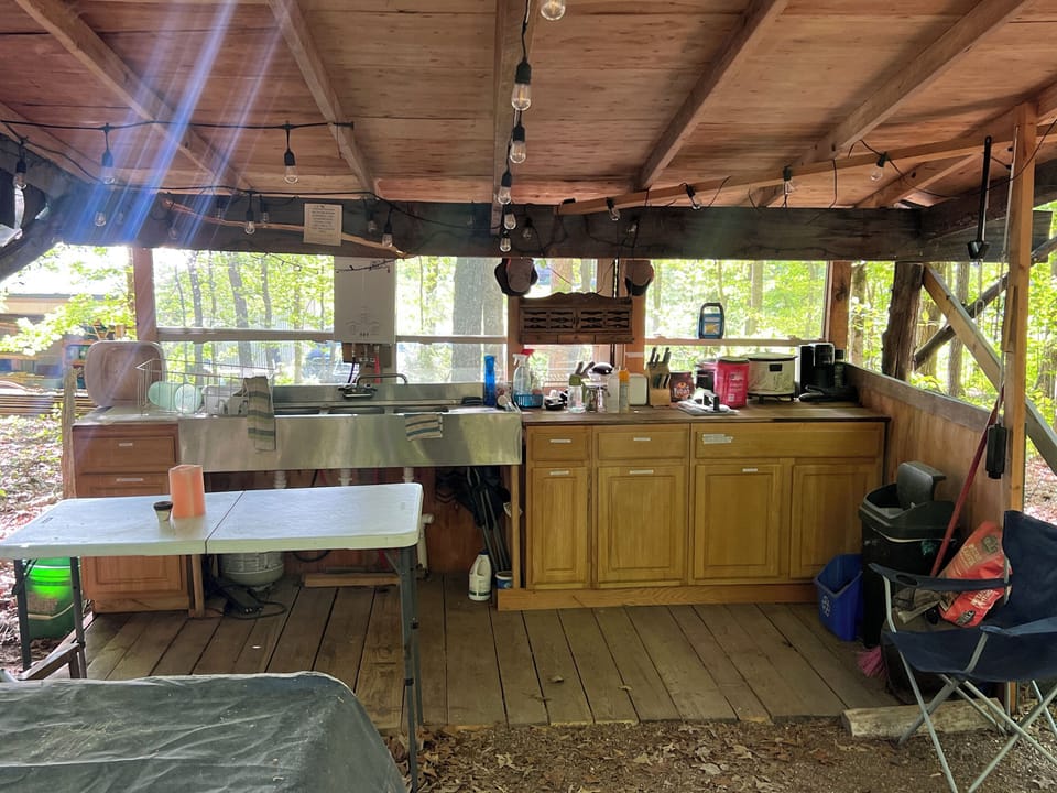 Fully stock outdoor kitchen with 3 burner stove, blackstone and charcoal grill.