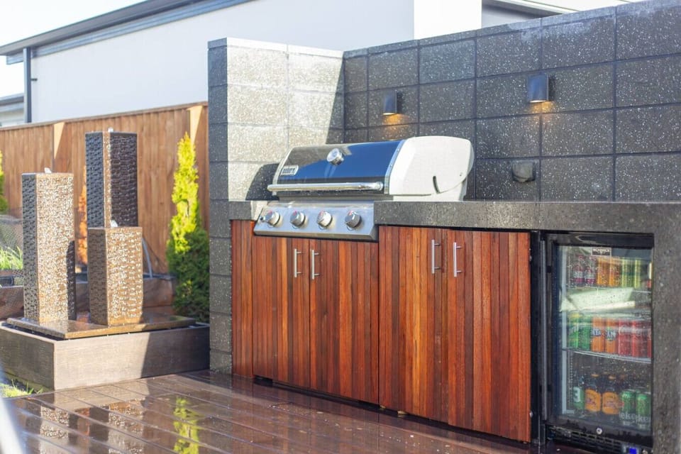 Fire up your grill and gather everyone around your outdoor kitchen—the beverage fridge keeps drinks ice cold while you cook.