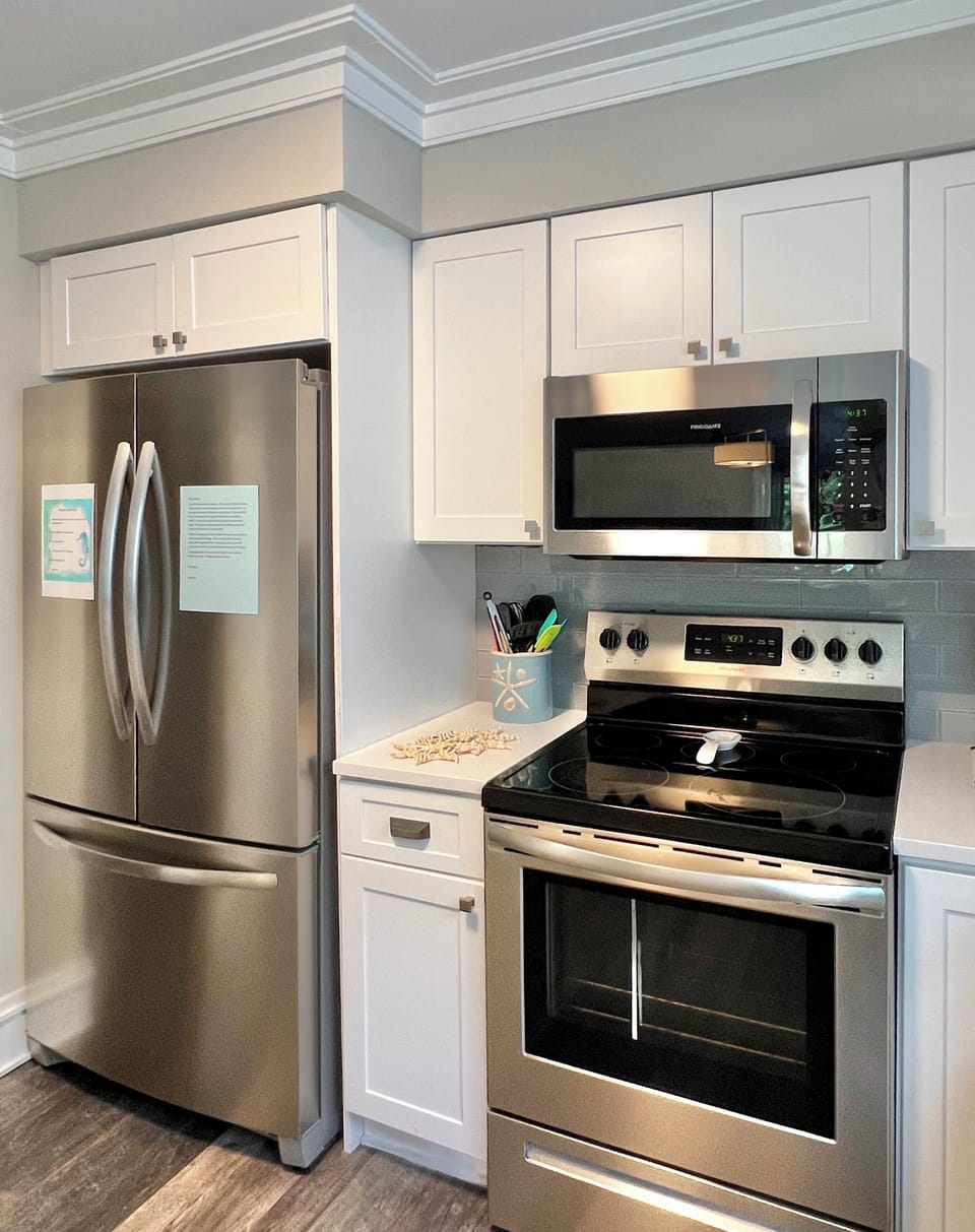 The kitchen includes a microwave, range and spacious refrigerator 