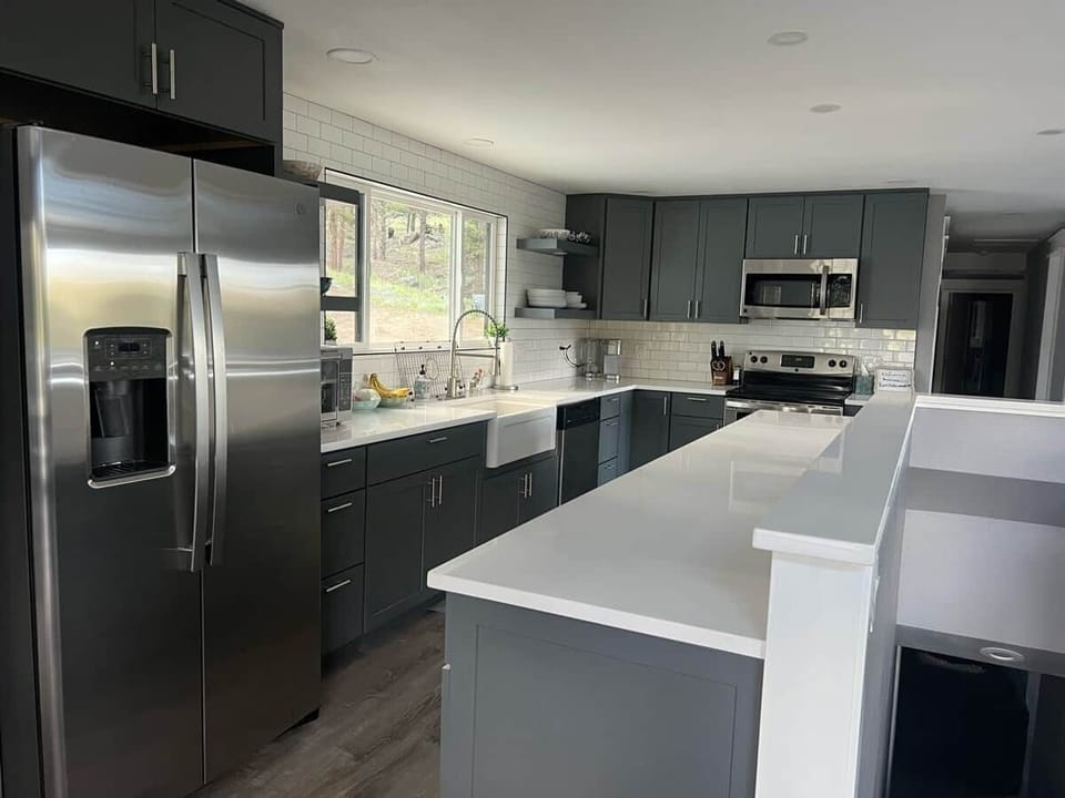 Large kitchen with beautiful views, a farmhouse sink, quartz counter tops, an air fryer, and a Keuring coffee maker