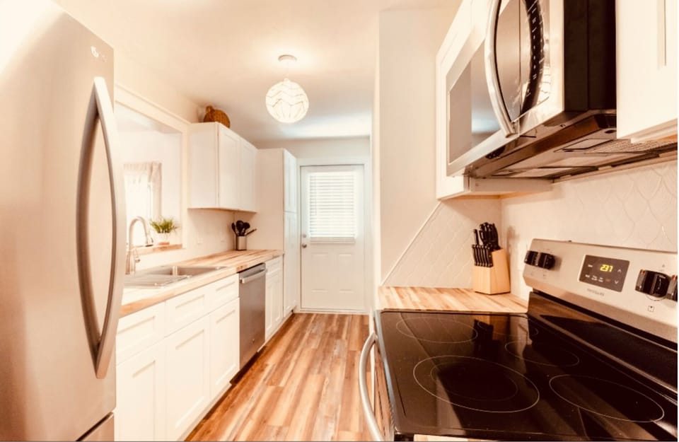 Full custom kitchen. Stainless and butcher block finishes.