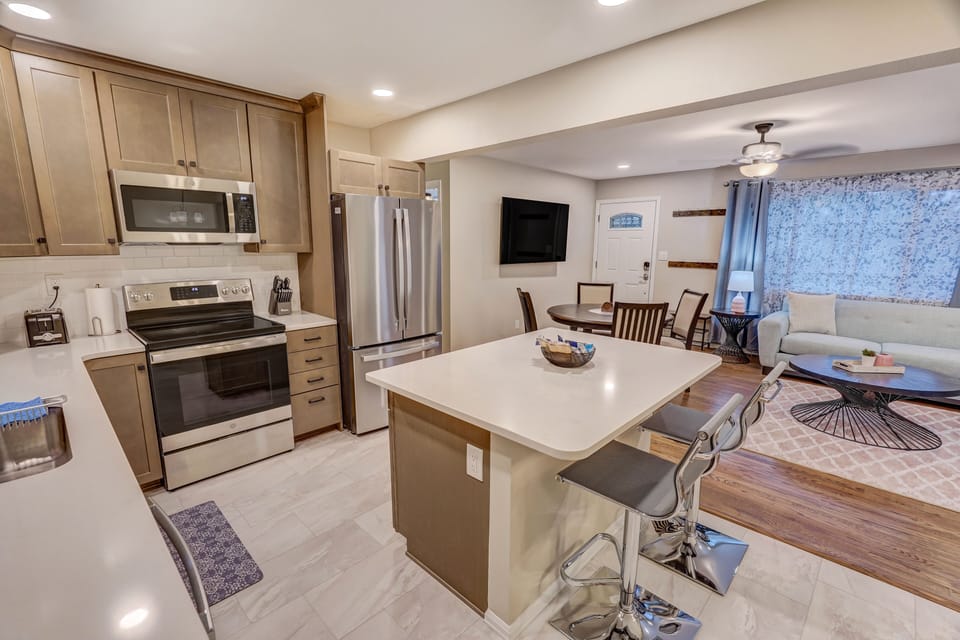Experience Fun and Socialization at Counter Seating on the Kitchen Island. 