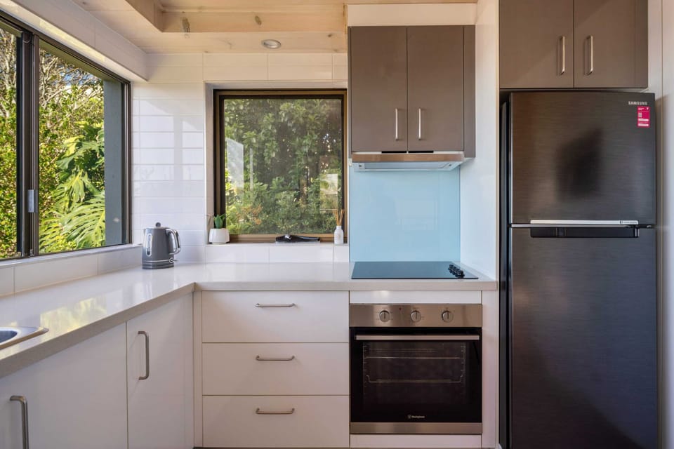 Fully equipped kitchen with modern appliances and generous bench space