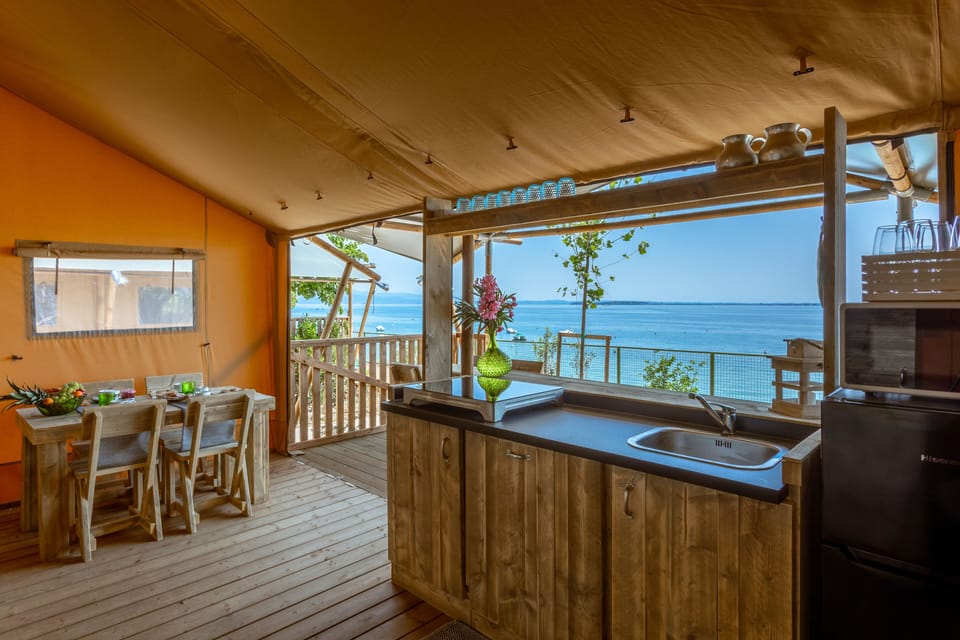 Deluxe Tent, Lake View | Living area | 32-inch Smart TV with digital channels, table tennis, books