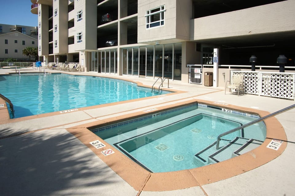 Main pool, hot tub and lounge chairs at South Shore Villas 502, a Crescent Beach vacation rental