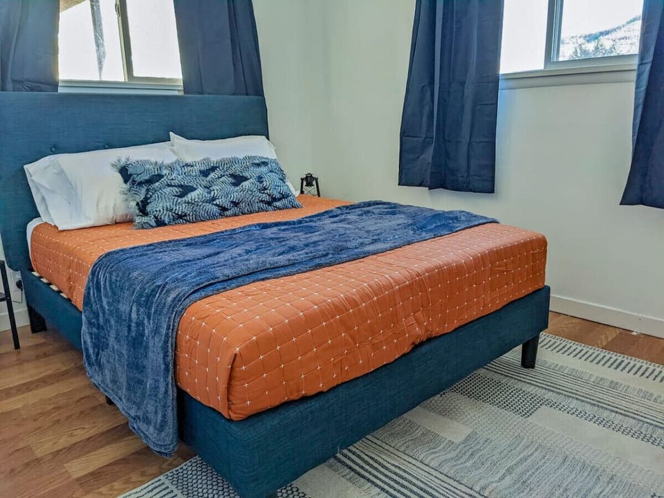 Bright queen bedroom with plush bedding