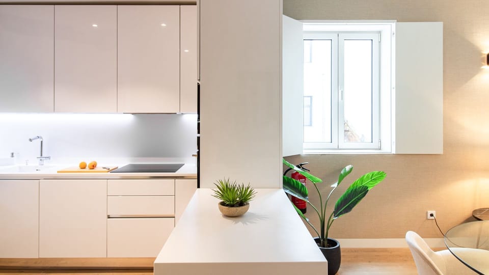 Prepare delicious meals effortlessly in this sleek, modern kitchen, featuring pristine white cabinetry and ambient under-cabinet lighting. Enjoy a seamless flow into the living area, perfect for entertaining or a quiet evening in. 
#ModernKitchen #SleekDe