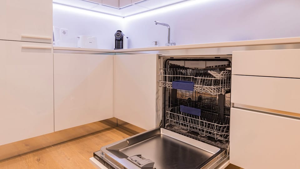 Prepare and enjoy your meals without a second thought about cleanup, thanks to the convenient, full-sized dishwasher seamlessly integrated into this stylish, contemporary kitchen. Its bright and functional design ensures effortless meal preparation and ti