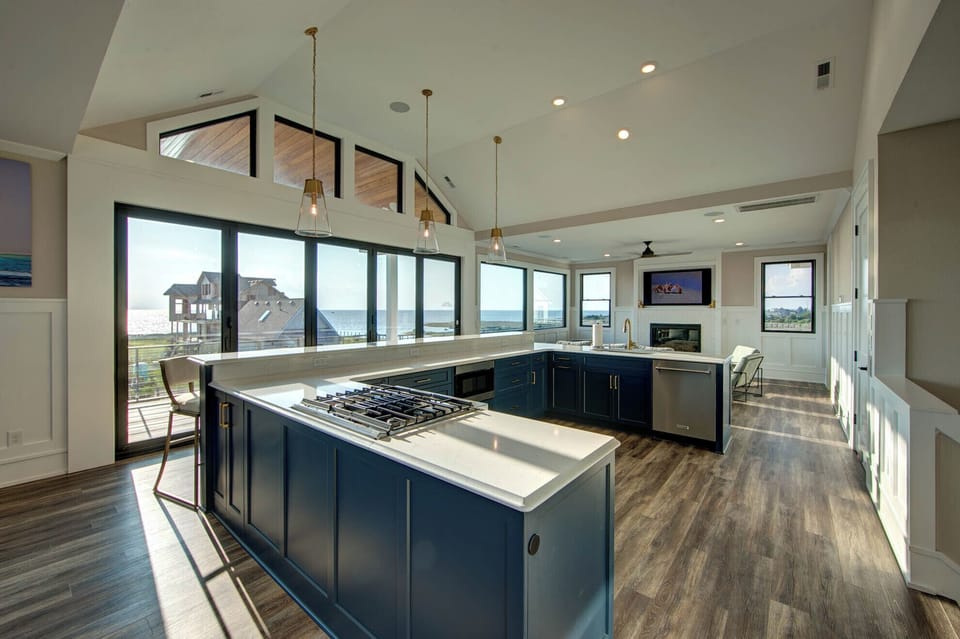 Large open kitchen with gorgeous views! Full glass doors open to deck.