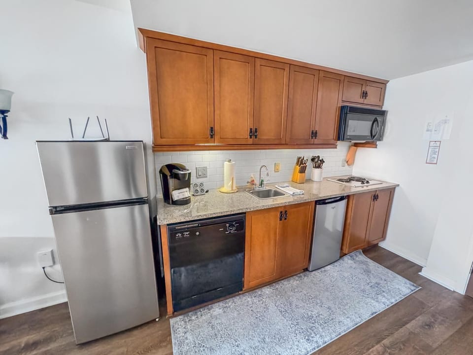 Fully equipped kitchen with modern appliances and warm wood cabinetry
