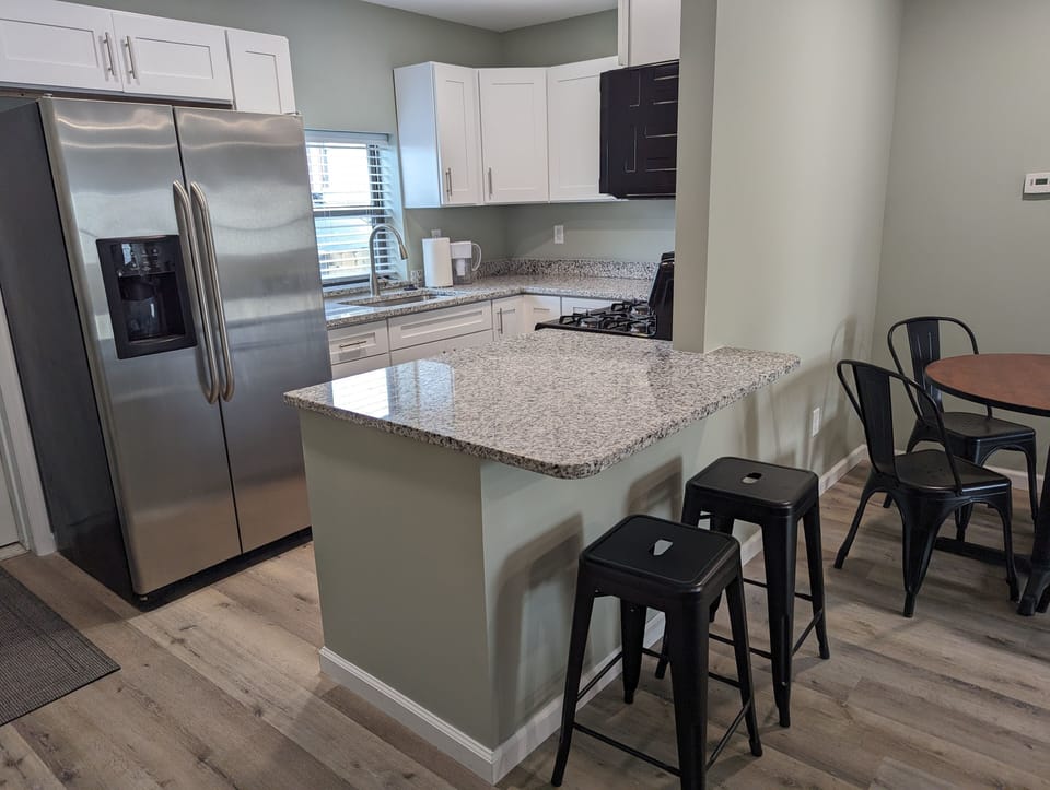 Well equipped kitchen with new cabinets and granite countertops
