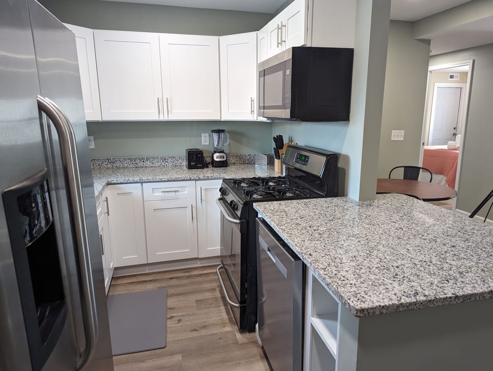Well equipped kitchen with new cabinets and granite countertops