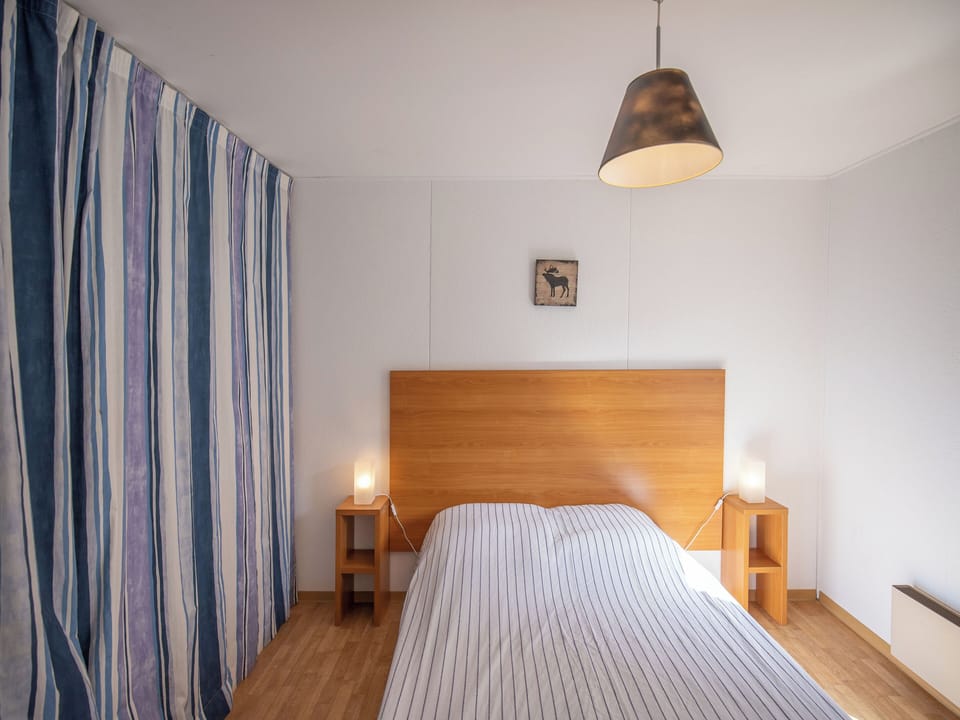 The bedroom features a double bed.