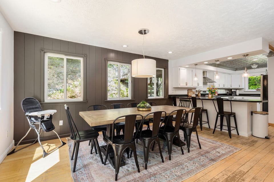 Open dining area flows into sleek kitchen w/ bar seating, perfect for shared meals