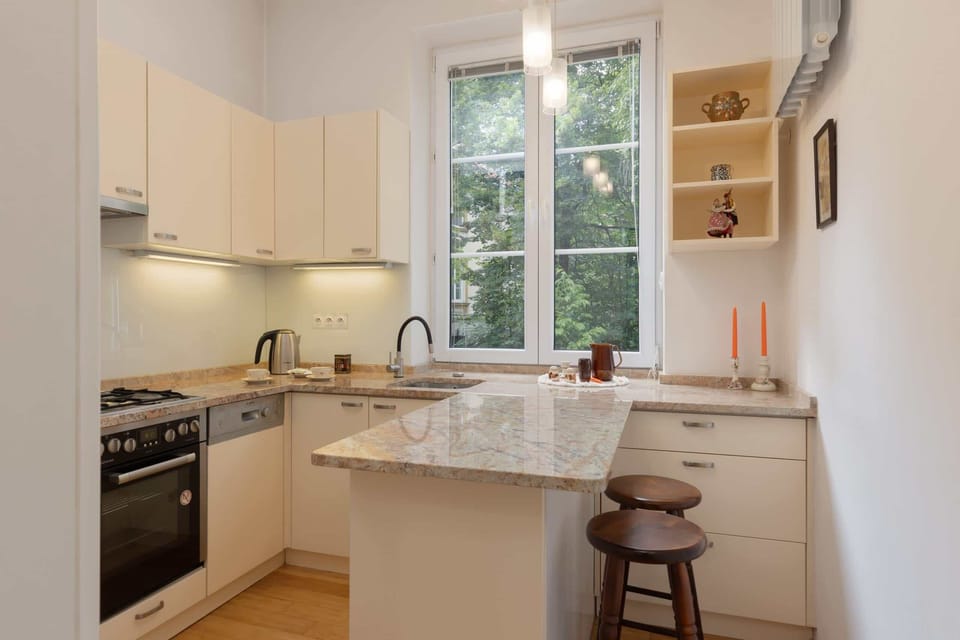 Kitchenette with oven and refrigerator. 