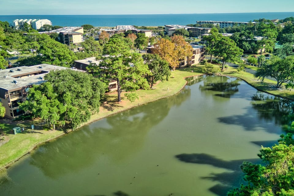 Photo taken directly above home and shows view of the lagoon located behind the home and the close proximity to the beach.