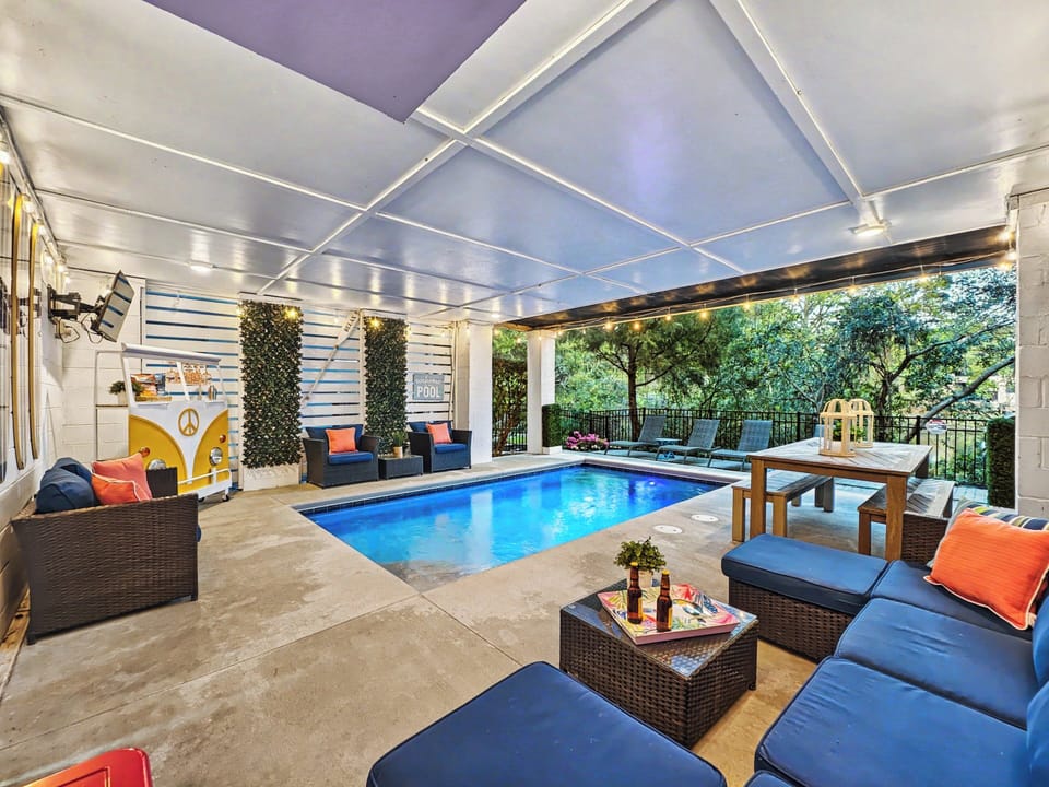 Heated pool in a fun setting with ample seating for guests to enjoy the outdoors after a memorable day at Folly Fields beach on Hilton Head Island.