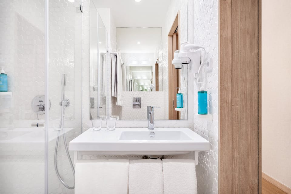 Shower, rainfall showerhead, hair dryer, towels