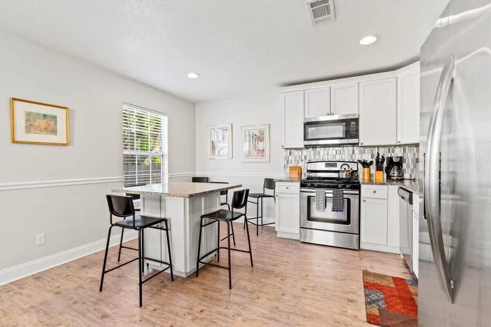 Spacious and luminous dining and kitchen area.