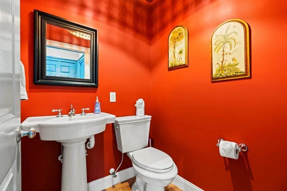 Vibrant powder room with pedestal sink for your convenience.