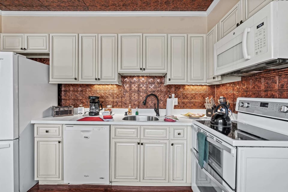 Whip up meals in our fully equipped kitchen with stylish copper backsplash.