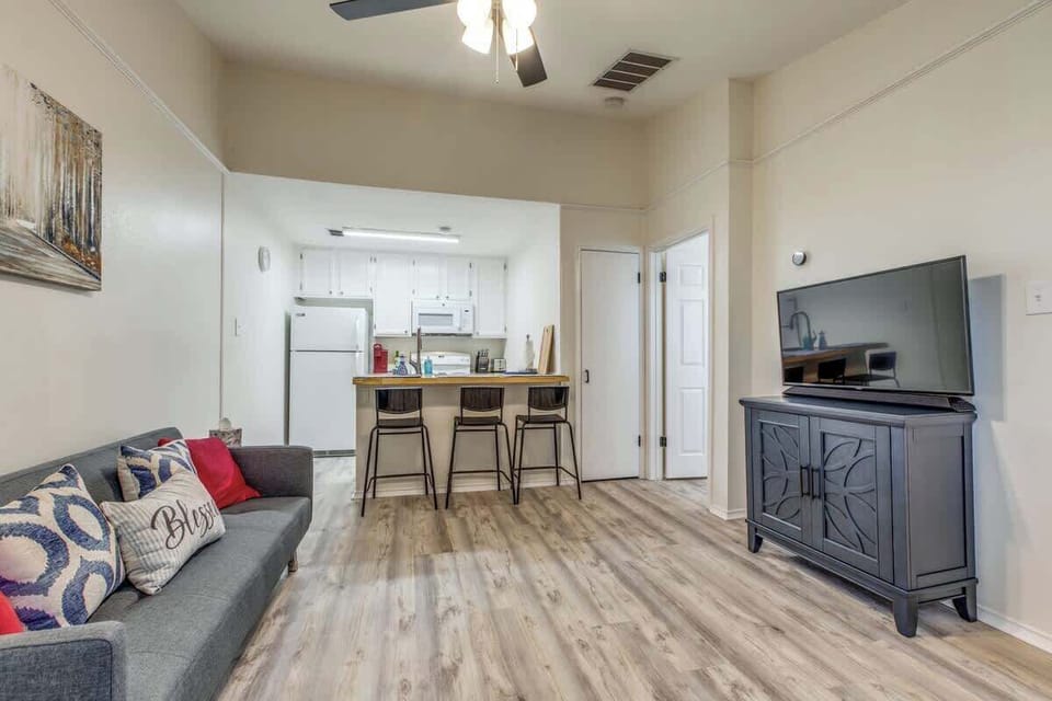 Comfortable space featuring a cozy living area, smart TV, breakfast bar, and fully stocked kitchenette—perfect for a relaxing getaway.