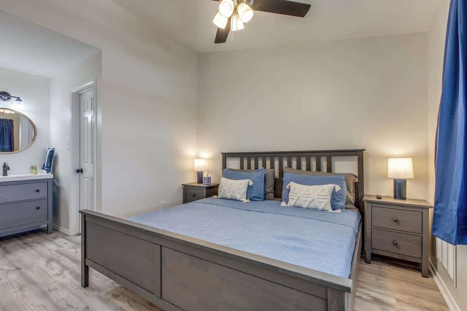 Comfortable bedroom with a spacious king-size bed, modern furnishings, and an en-suite bathroom for a relaxing and private retreat.