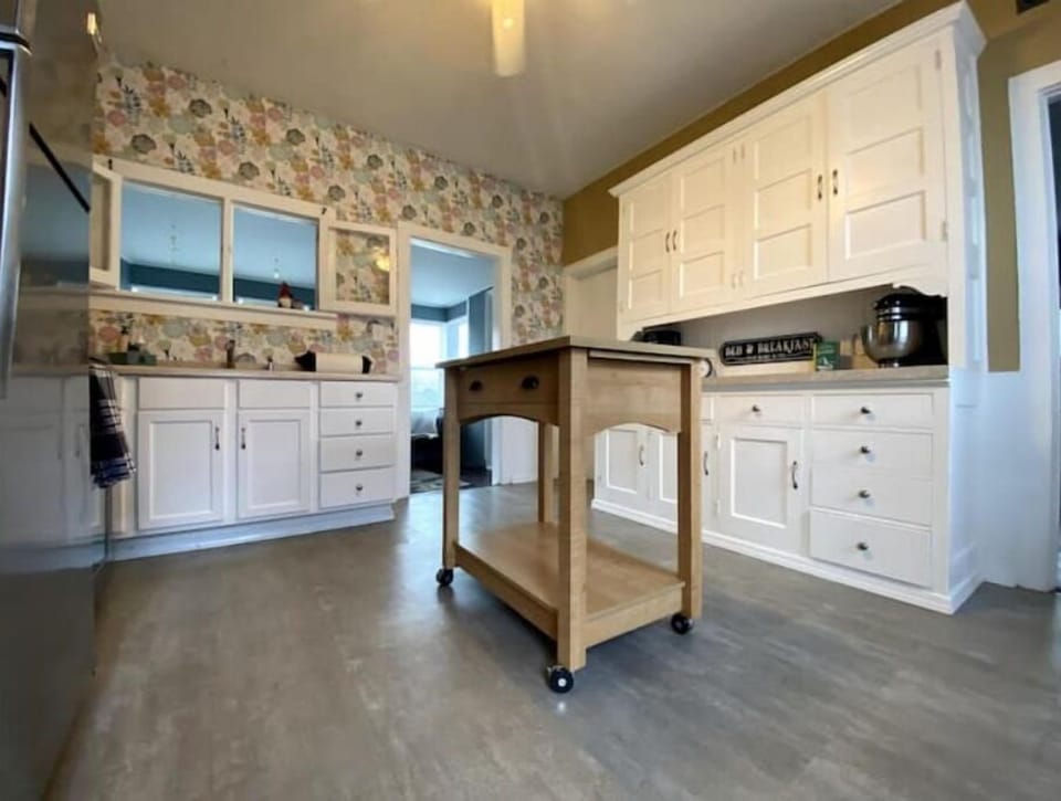 Bright and cheery kitchen loaded with storage and cookware.