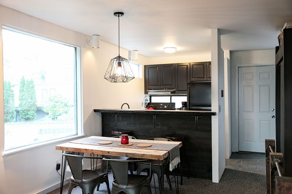 Dining table in area behind kitchen