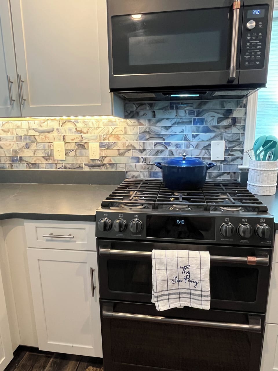 Recent updates include gorgeous glass backsplash in our well stocked kitchen