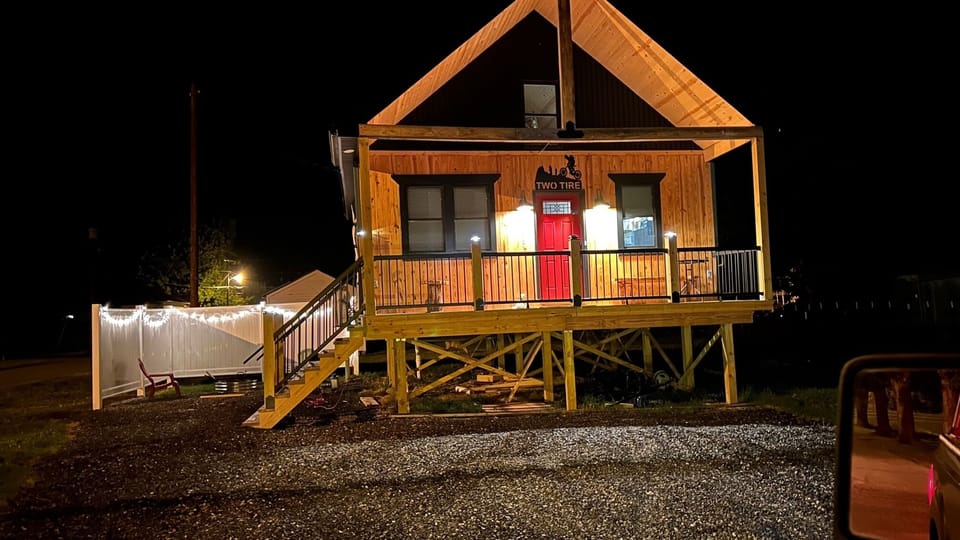 Cozy cabin with firepit and full porch with plenty of seating to relax 
