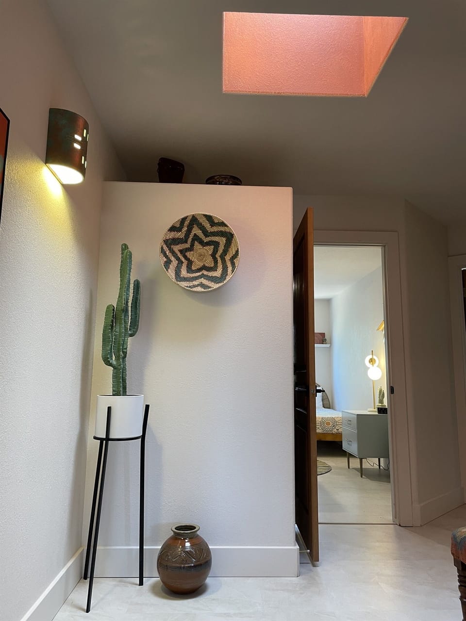 The beautiful upstairs landing features a rosy pink skylight.