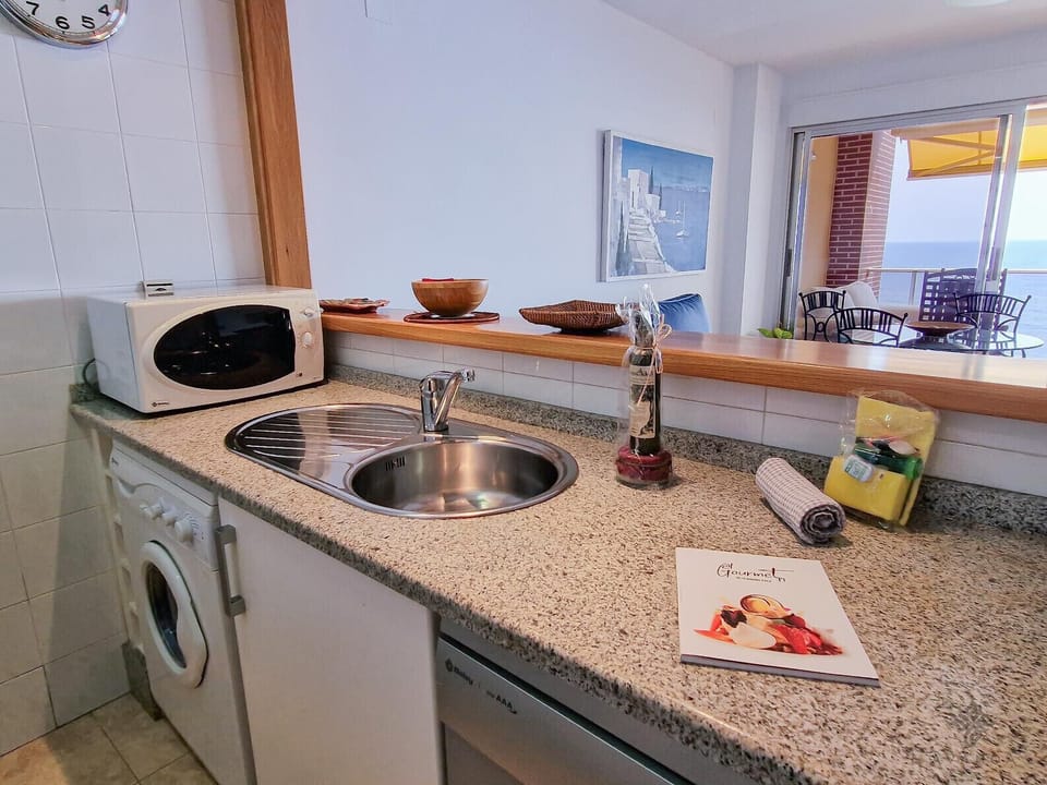 Fitted kitchen with serving hatch.