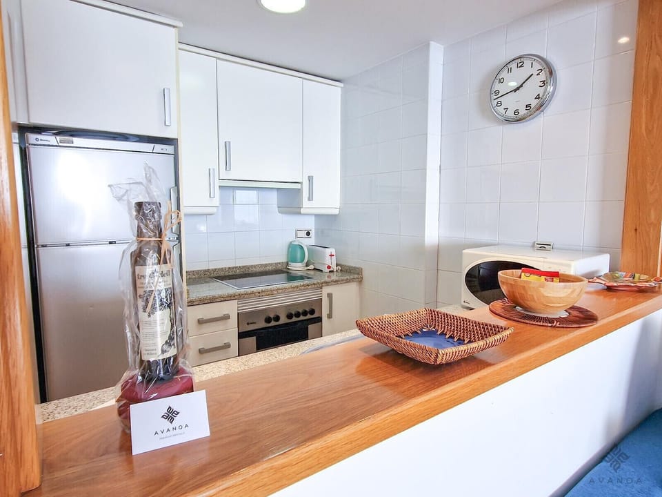 Fitted kitchen with serving hatch.