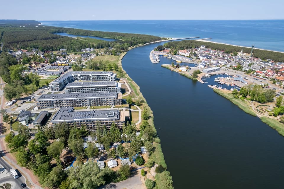 A stunning aerial view of the apartment complex and surrounding waterway, emphasizing its prime location.