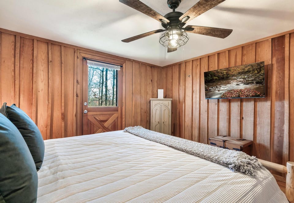 Bedroom Retreat: Bright wood paneling and natural light 