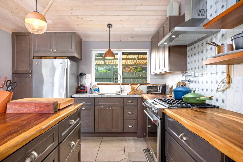 Bathed in honeyed light and framed by whispering foliage, this kitchen is a quiet symphony of nature and nurture combined   
