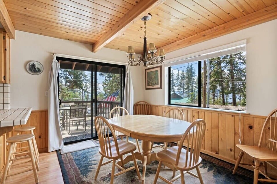 The dining area boasts a table with seating for six tucked in a corner with windows all around so you can enjoy the views over the surrounding area while you dine.
