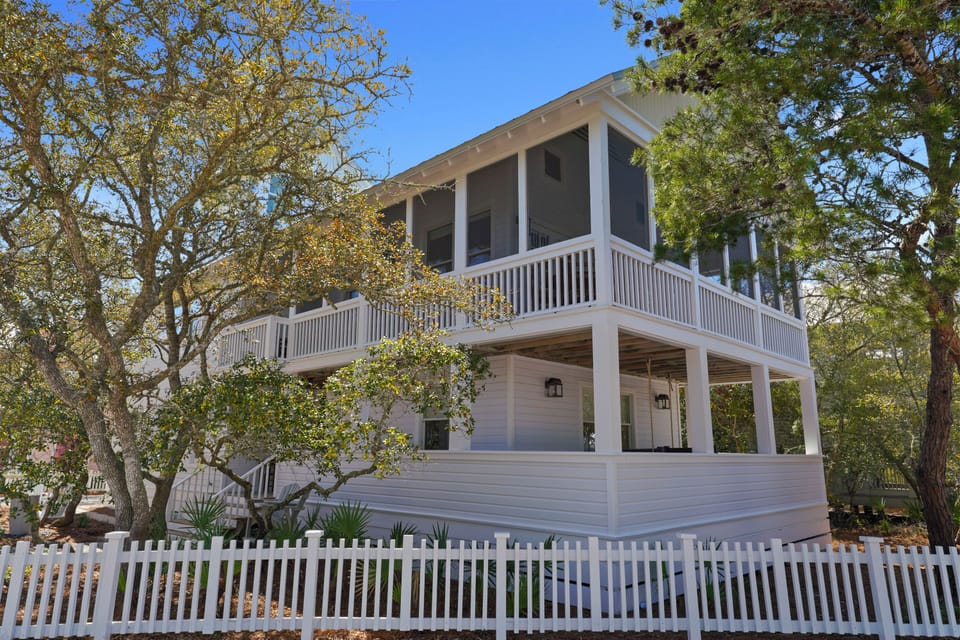 EXTERIOR VIEW WITH WRAP AROUND PORCH AND FENCED, PRIVATE YARD