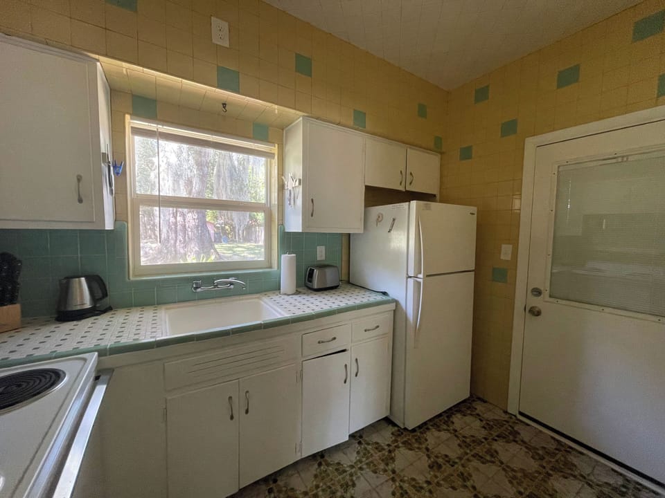 backdoor leads from kitchen to screen porch - laundry off porch