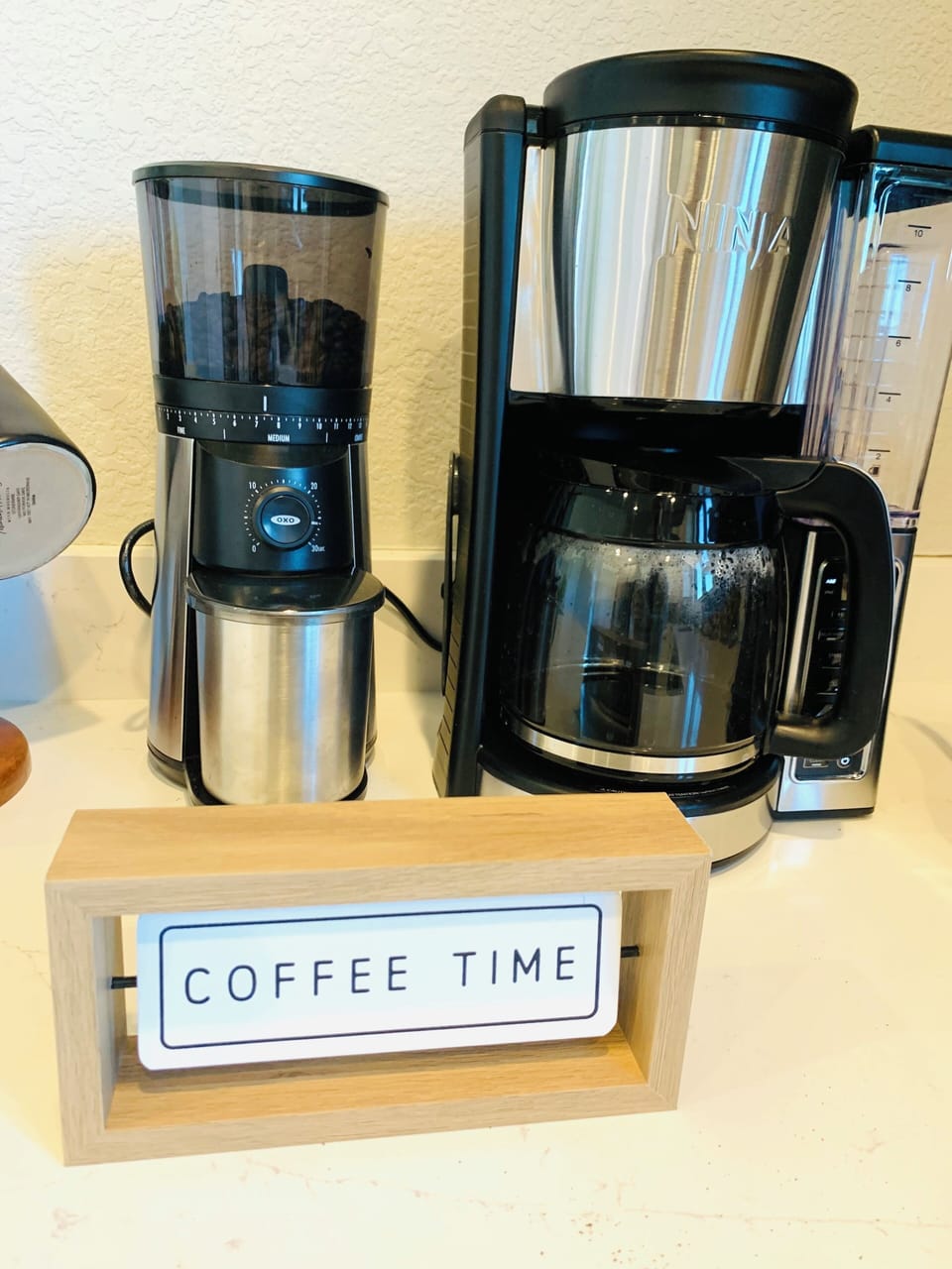 Coffee and tea bar station fit with new coffee maker, grinder, and tea kettle.