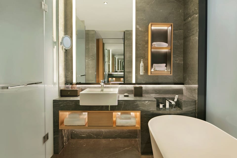 Separate tub and shower, rainfall showerhead, designer toiletries
