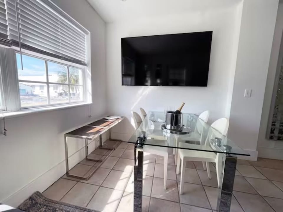 Dining table with chairs
The 7th bedroom or Livingroom, depending on the bed set up. Bright living room with a large 75-in Smart TV and oversized window with a partial city view tucked away from any street noise in the heart of South Beach's Entertaining