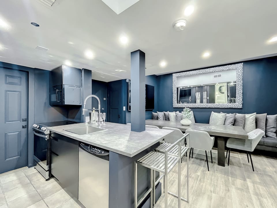 Full-size kitchen with brand new state-of-art Samsung stove, convection oven, air fryer, island bar with in-kitchen dining, entertaining 70-inch smart TV in the dining room, 50-inch in kitchen, stone dining table for up to 12 persons & bar seating.